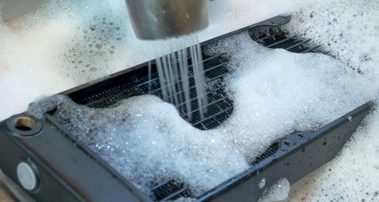 Cleaning the cooling fins of a PC radiator with soap and water